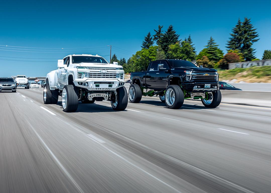 Two lifted trucks on the road in Seattle, WA.