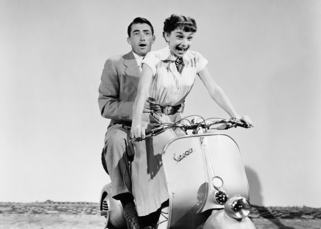 Gregory Peck and Audrey Hepburn riding a Vespa in the 1953 comedic romance 'Roman Holiday'