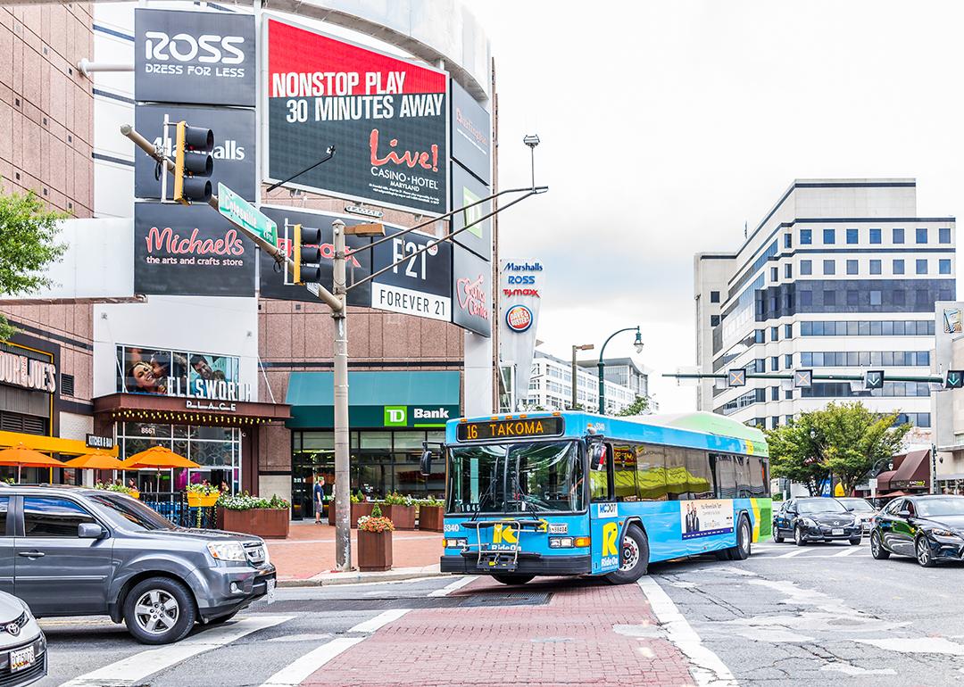 Bus and cars driving in the streets of a downtown area in a city in Maryland.