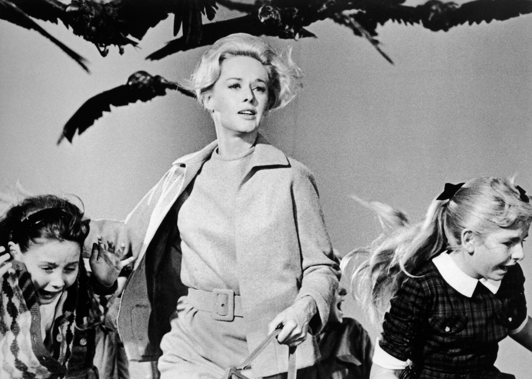 American actor Tippi Hedren and a group of children run away from the attacking crows in a still from the film 'The Birds' directed by Alfred Hitchcock.