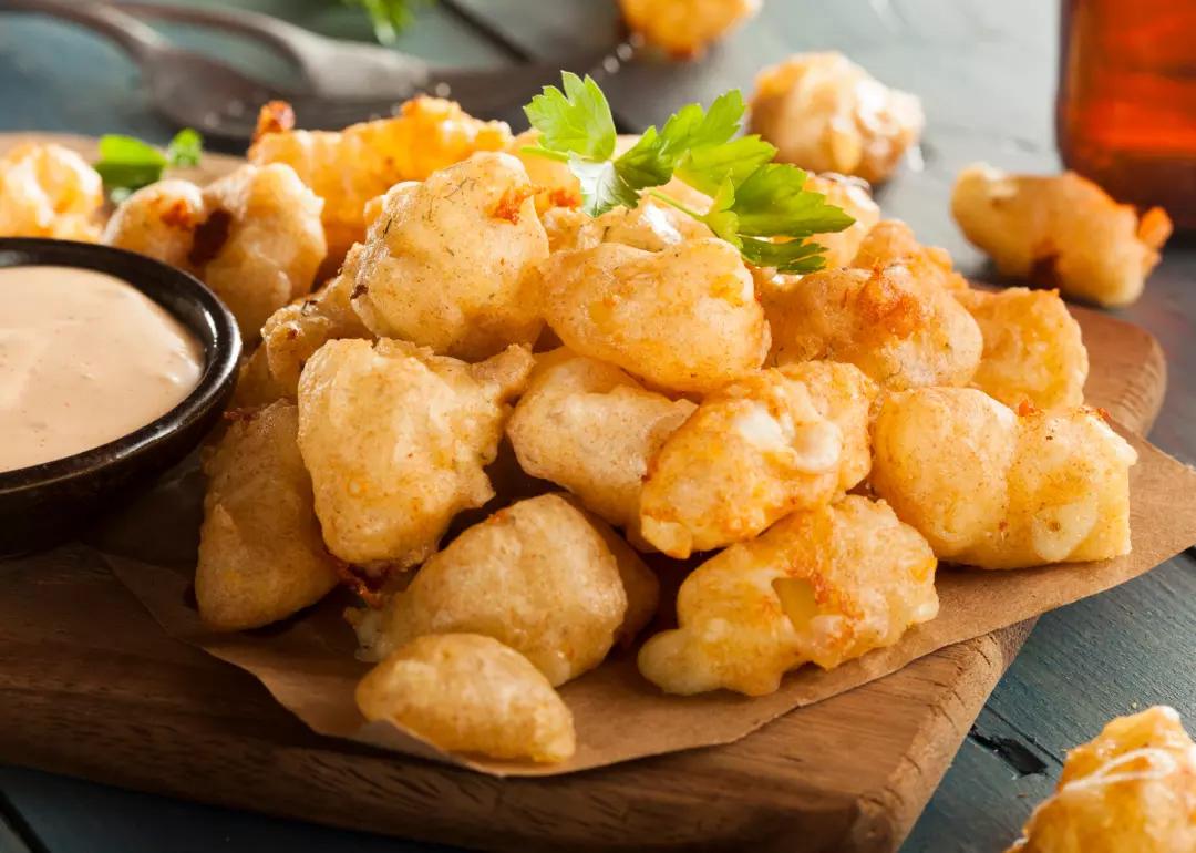 Beer battered Wisconsin cheese curds with dipping sauce.