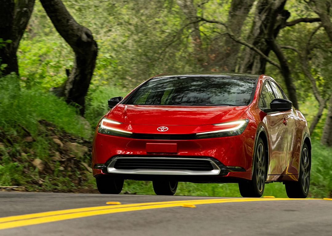 A red 2025 Toyota Prius on the road.