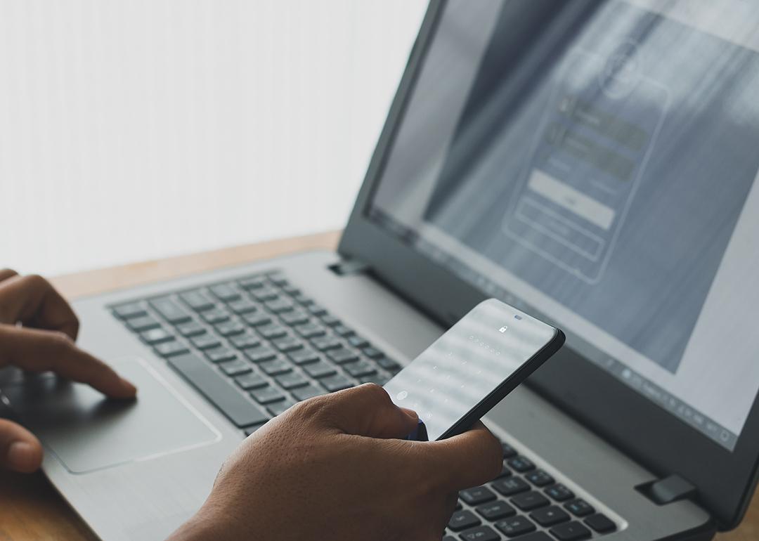 Person setting up a two-factor authentication login using a laptop and a phone.