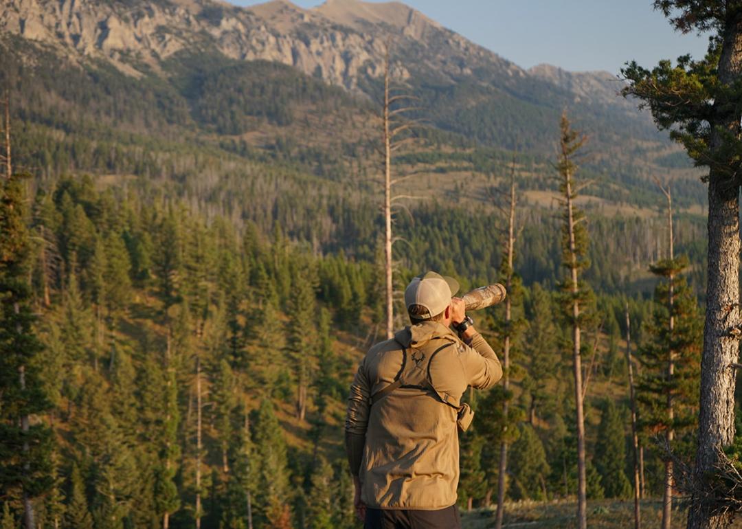 Man looking over a mountainous area and sightseeing. 