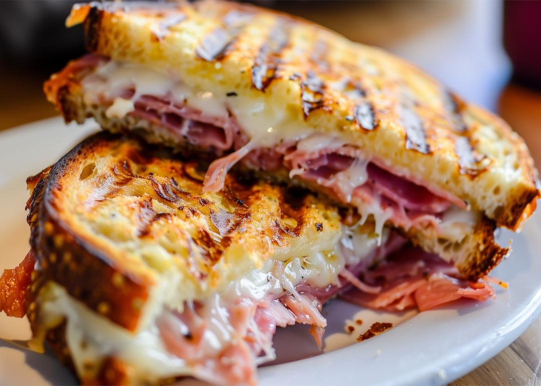 A reuben sandwich that's been grilled with Swiss cheese, sauerkraut, mustard, and corned beef. 