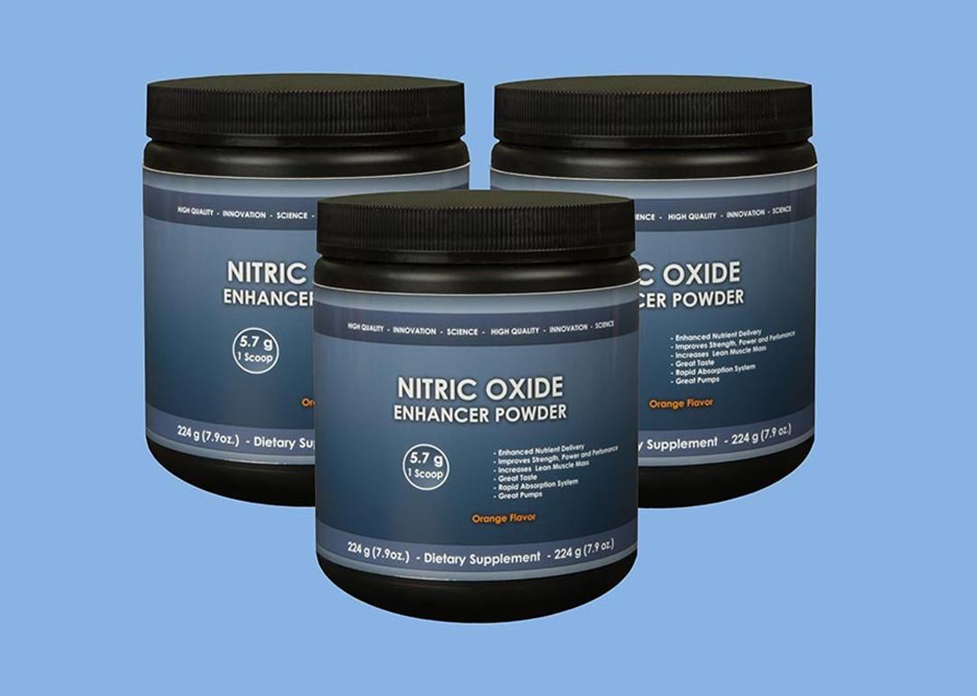 Three jars of nitric oxide supplement powder in blue background.