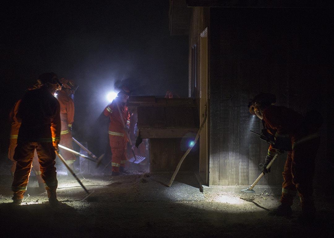 The Puerta la Cruz female inmate firefighter crew clears vegetation near homes in Dry Creek Canyon to try to save them as the Partrick Fire approaches west of Napa, Calif.