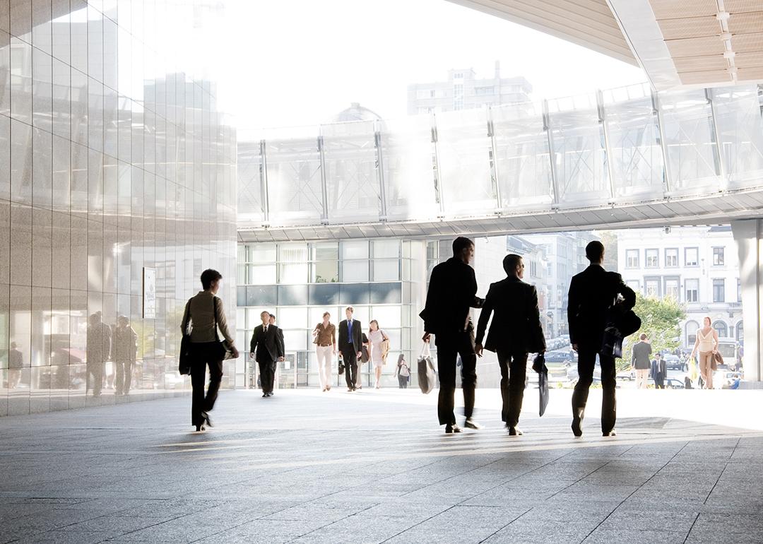 Business people leaving from their office building.