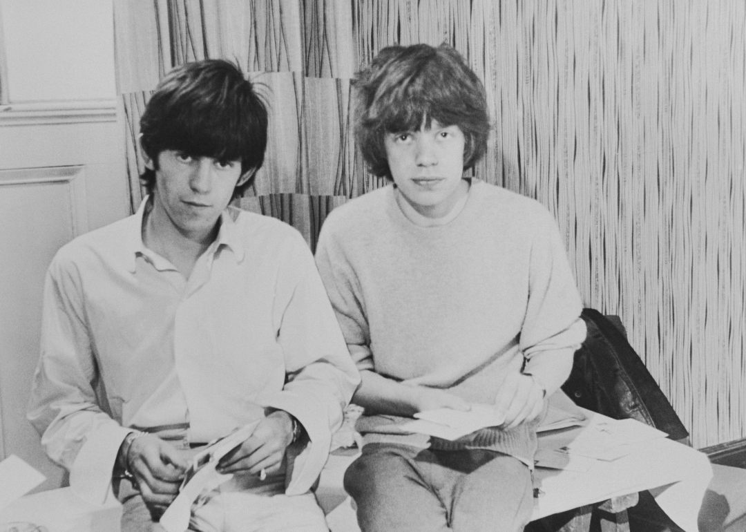 Rolling Stones singer Mick Jagger and guitarist Keith Richards opening fan mail during the early days of the band, circa 1963. 