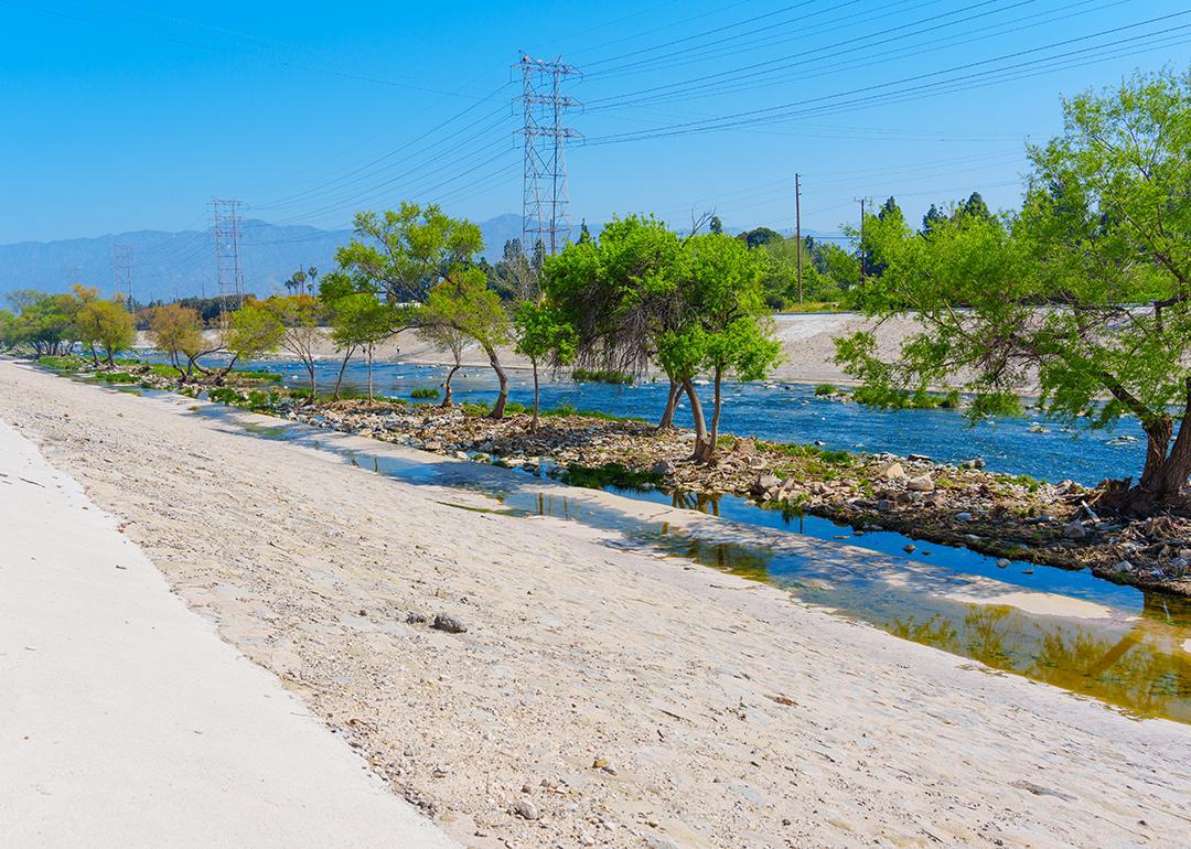 View of the vegetation and sandy banks in Los Angeles River in Elysian Valley.