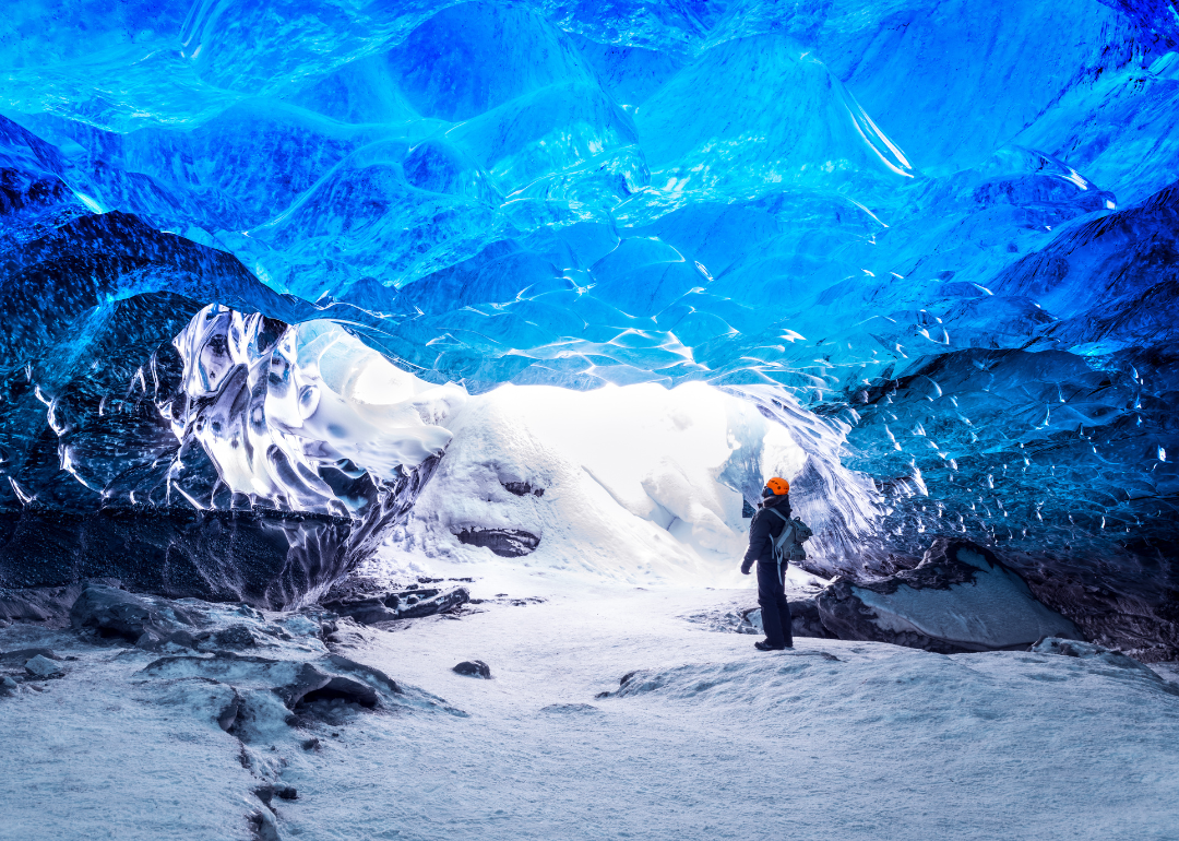 A person standing in an ice cave in the Skaftafell area of Vatnajokull National Park, Iceland