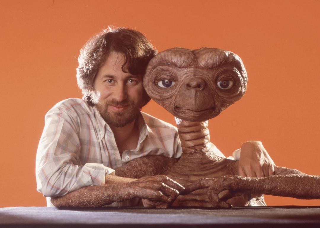 Director Steven Spielberg poses with E.T. in April 1982 in Los Angeles, California.