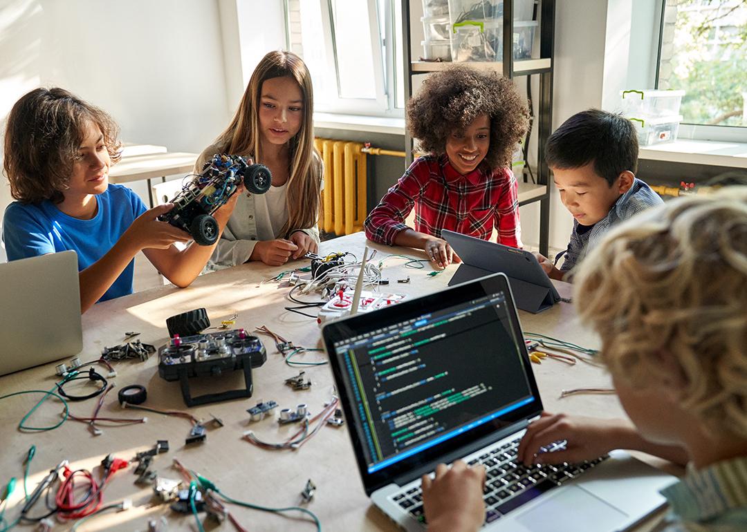 A diverse group of children happily engaging in a STEM class.