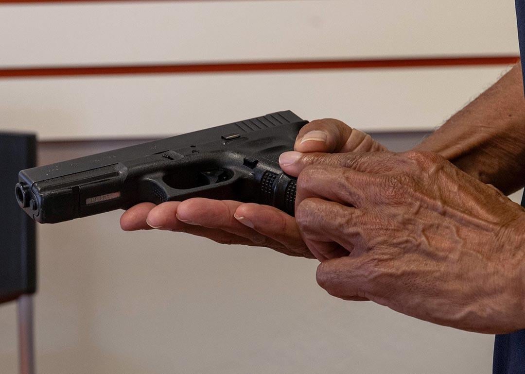 A certified firearms trainer in Lithonia, Georgia, holds a Glock 22 that was formerly a police gun.