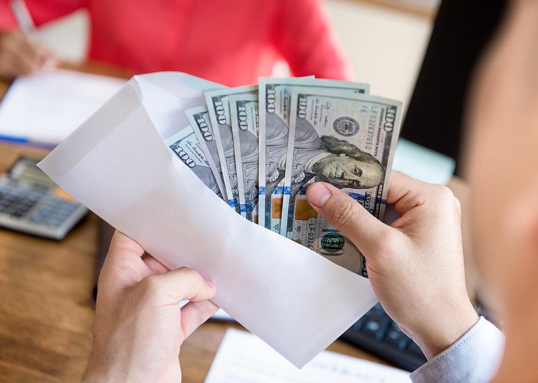 Banknotes being counted before enclosing in an envelope for payment.