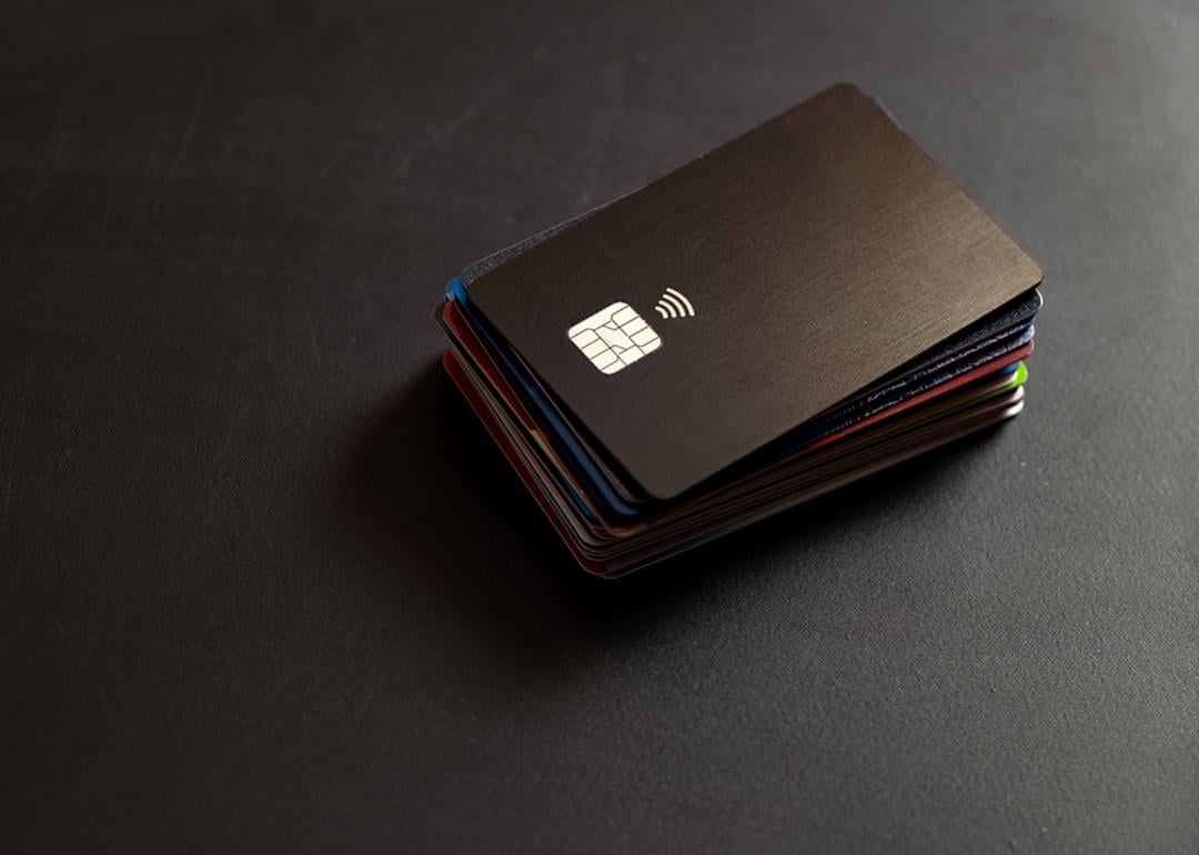 A stack of credit cards in a black background.