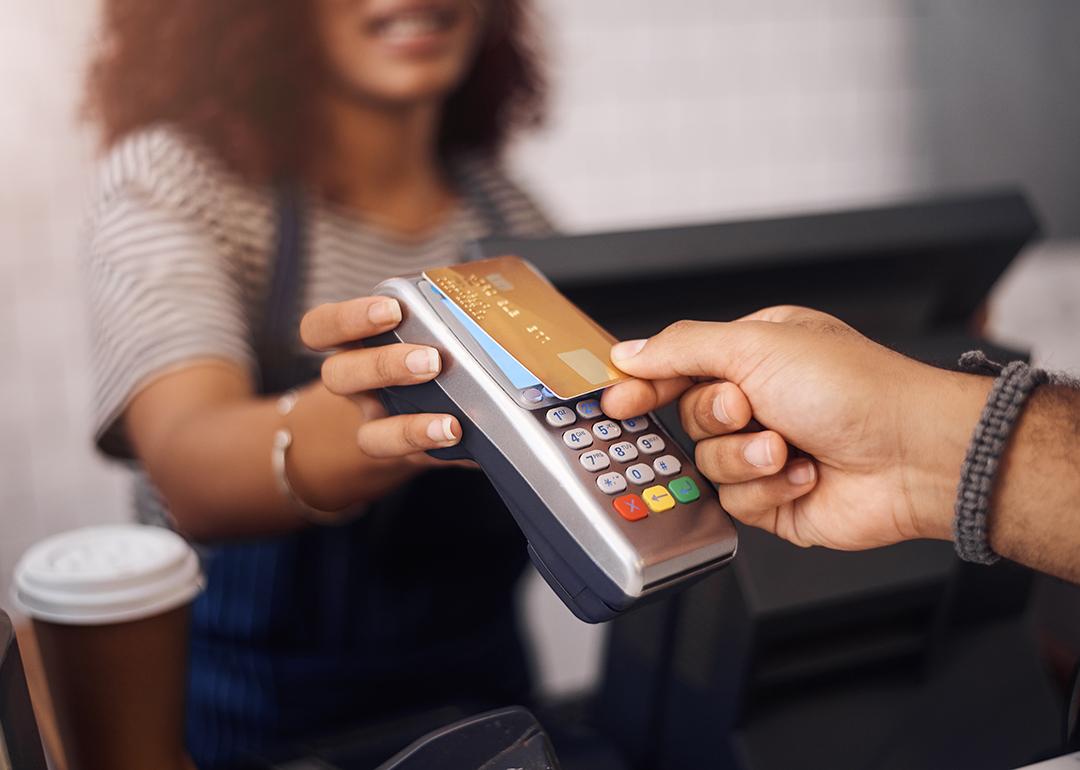 A small business barista receiving payment through a card purchase.