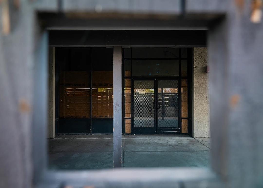 A shuttered door at a homeless shelter in Anaheim that is permanently shut down and partially boarded up.