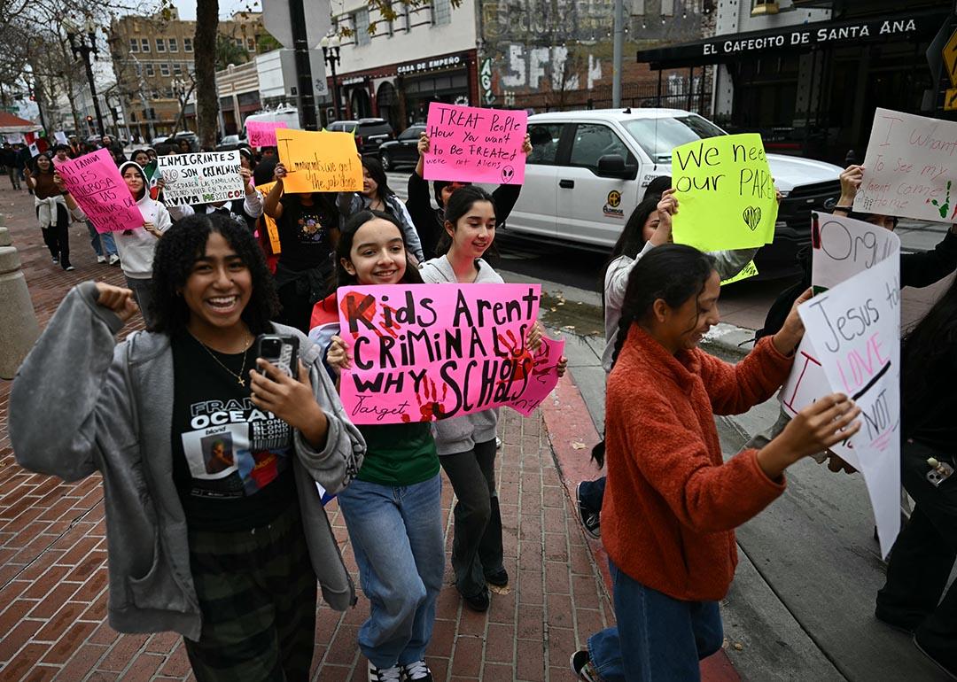 Students from Orange County Educational Arts Academy middle school hold placards in support of migrants outside the Ronald Reagan Federal Building and Courthouse in Santa Ana, California.