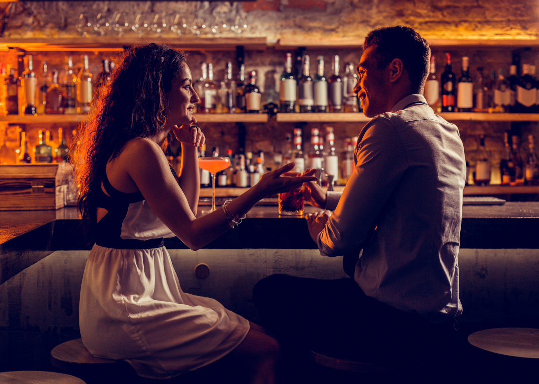 Young couple talking at a bar counter