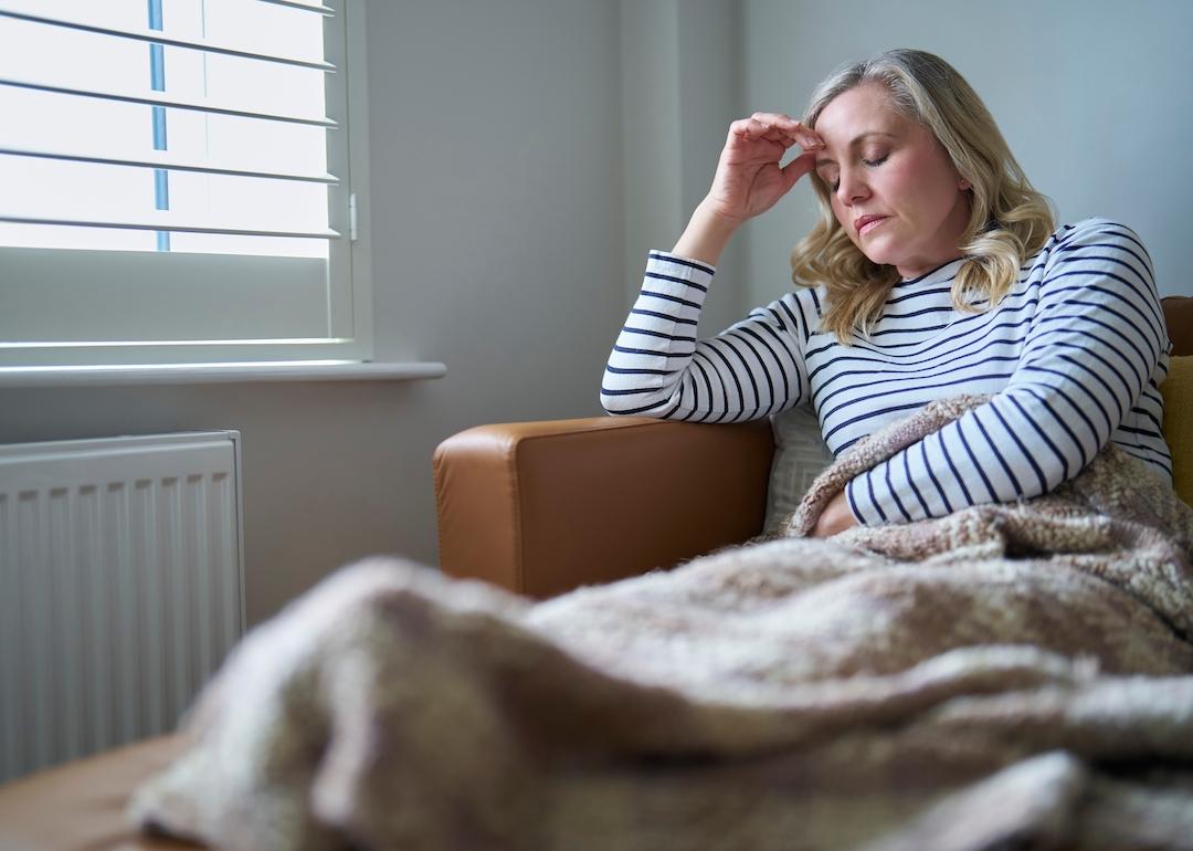 COVID long-hauler feeling unwell and laying on the couch.