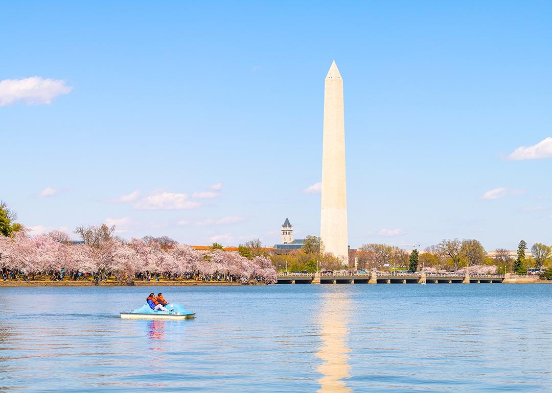 A couple on a pedal boat at the Tidal Basin with a view of the Washington Monument.