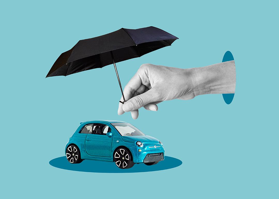 Car safety and insurance concept where an umbrella covers a car figure.