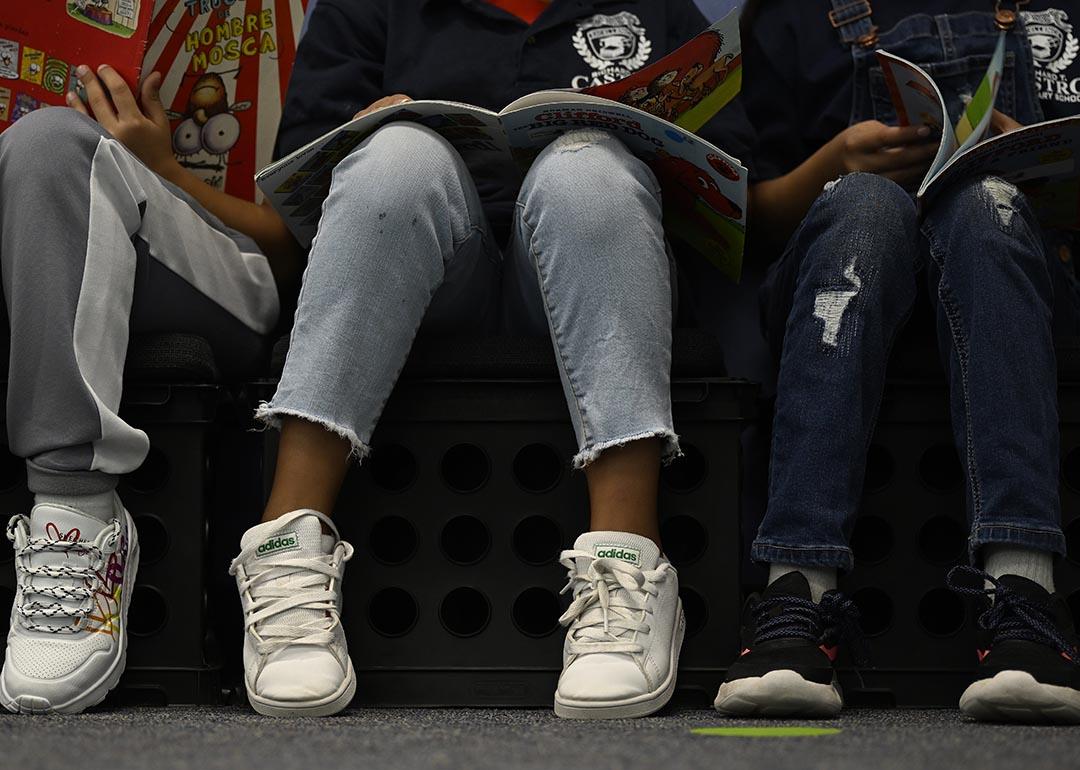 Low angle photo of third-graders reading books in at Castro Elementary.