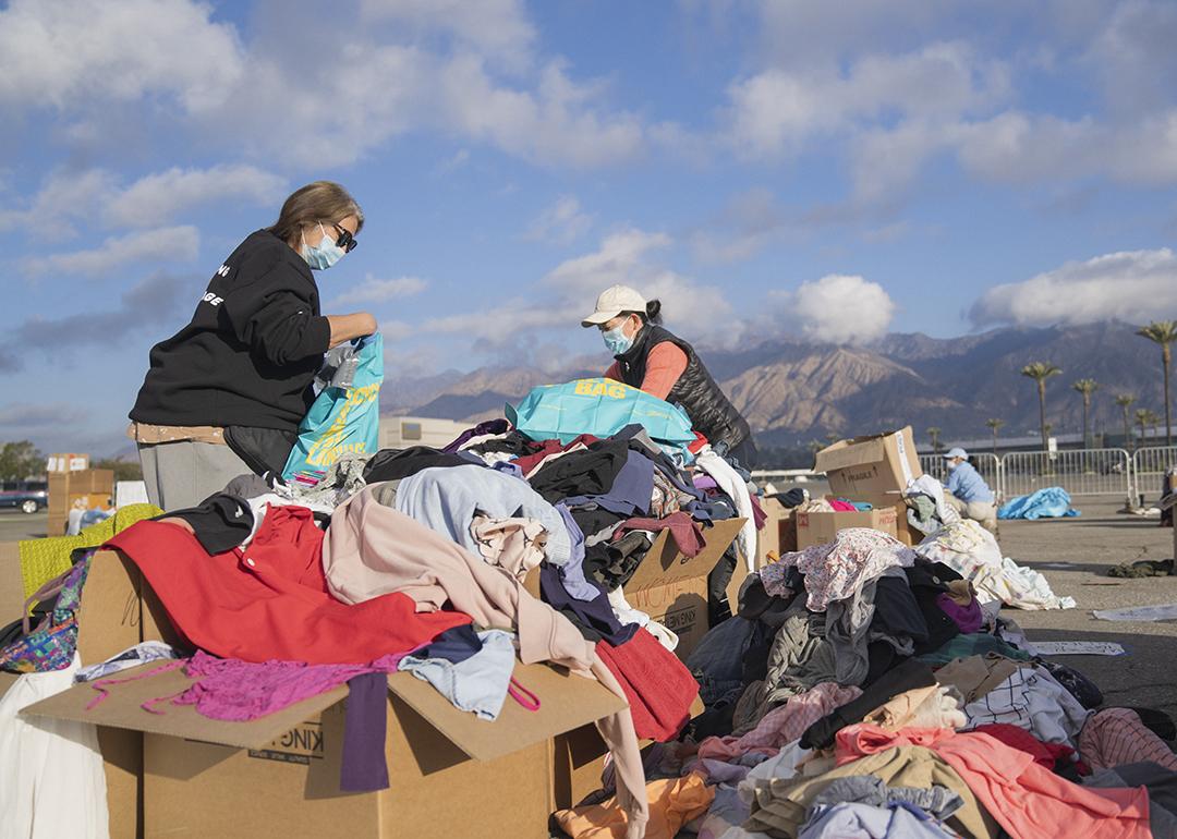 Volunteers sort through piles of clothing and textile donations made to California wildfire victims.