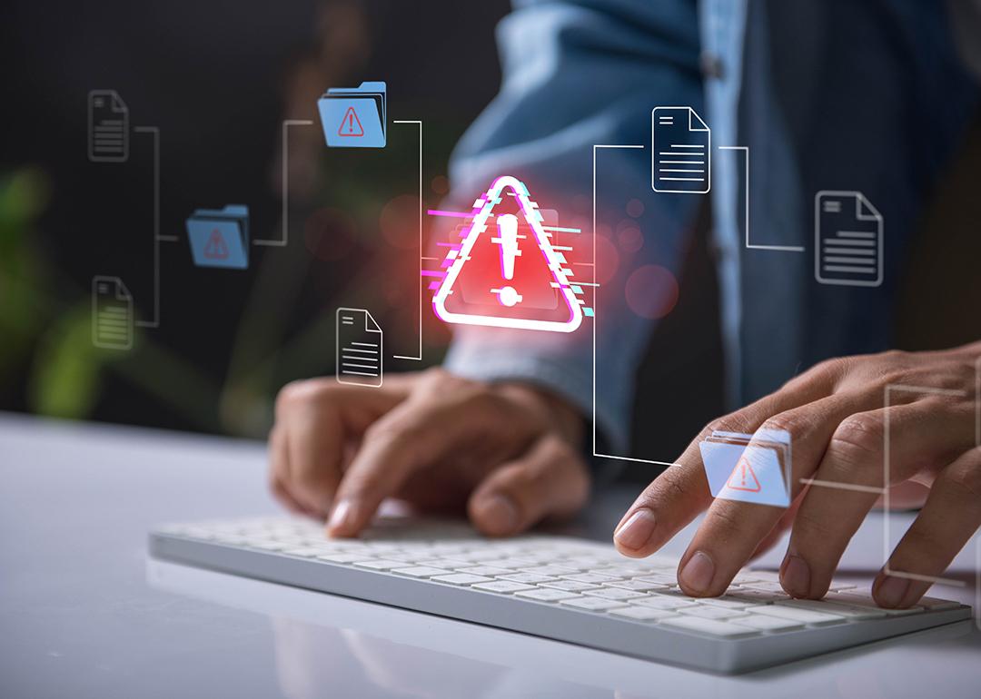 A company's network of information illustrated with malware and risk alert icon.