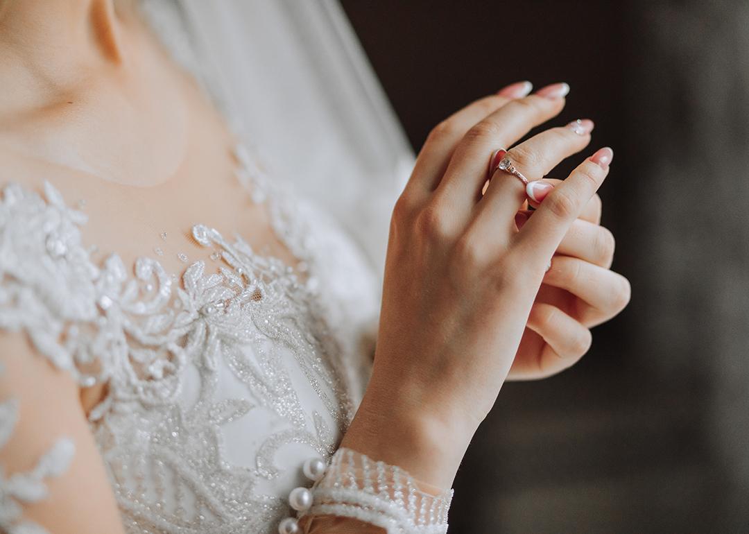 Close up on a bride's dress and ring during her wedding day.