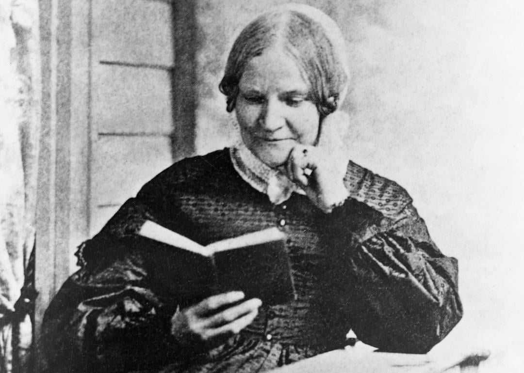 Lydia Maria Child reads a book on a front porch.