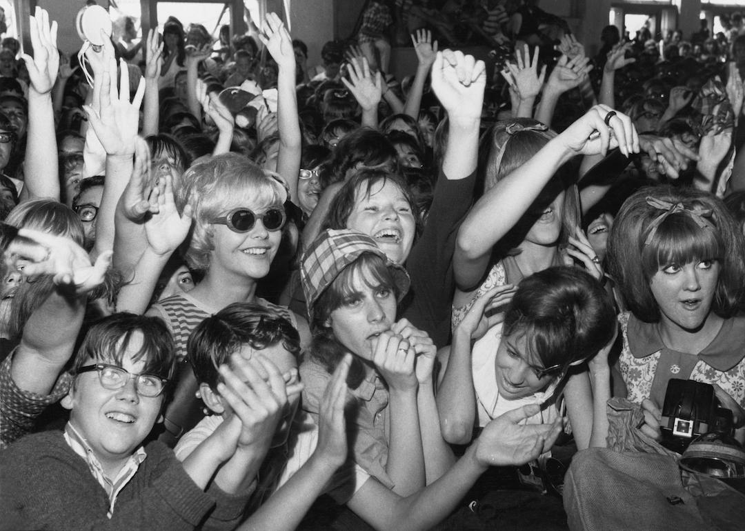 Sreaming fans cheer for rock and roll musicians on American Bandstand in the mid 1960s