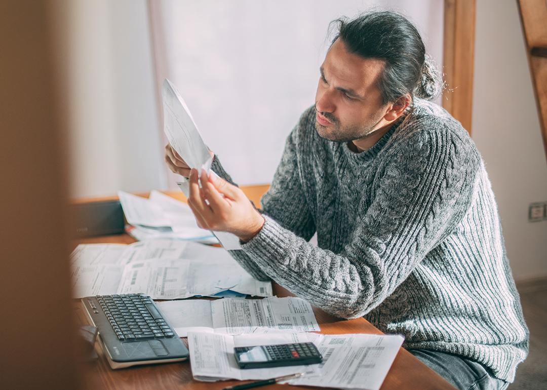 Homeowner looks at a power bill with confusion.