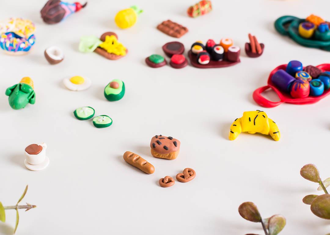 Miniature food such as baguette, breads, and fruits made out of polymer clay.