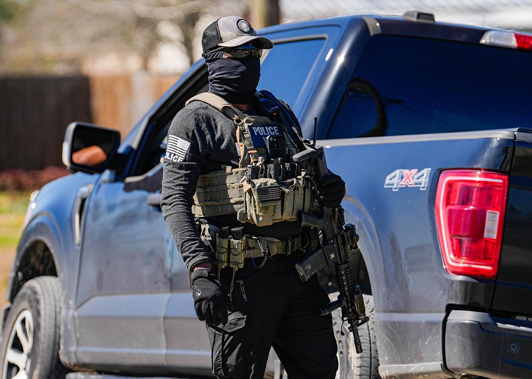 A federal agent identified as ICE conducts raids on a local tire shop business in Colony Ridge on February 24, 2025.