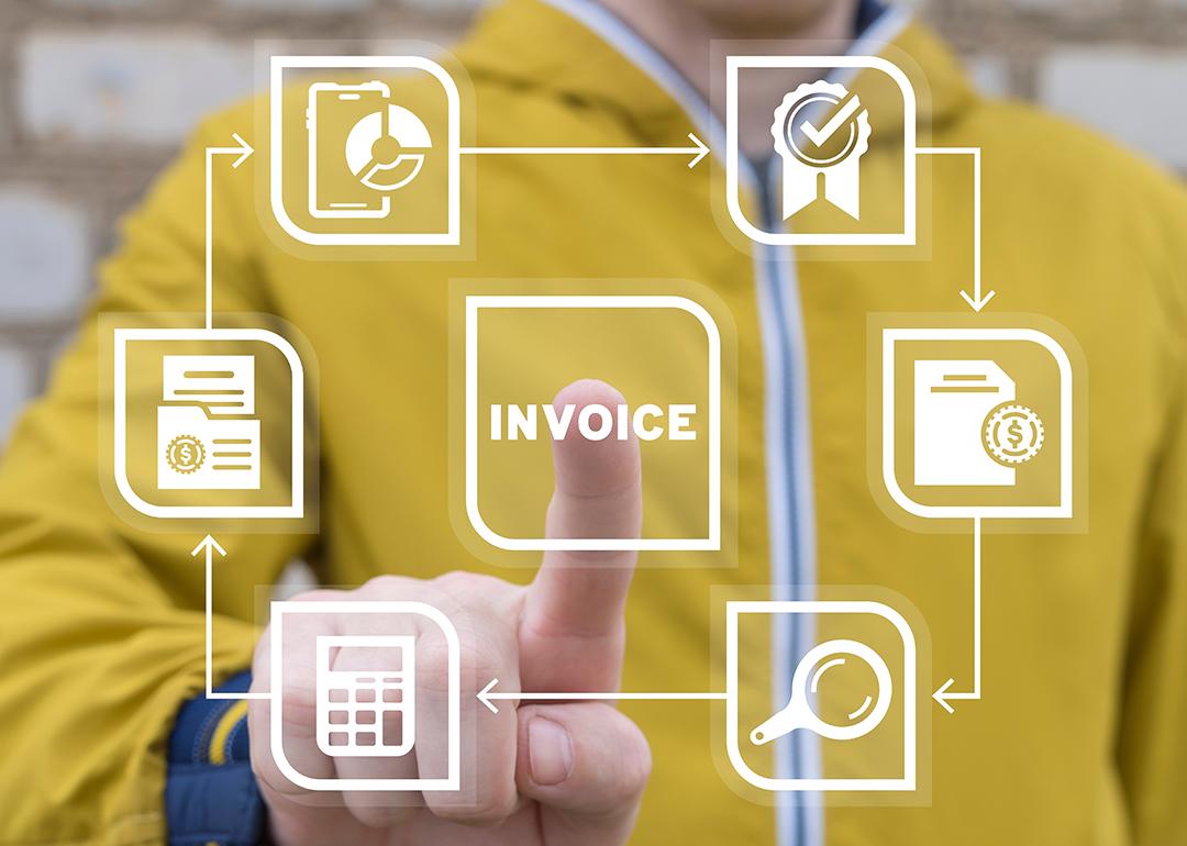 The word "invoice" being pressed by a businessperson in a virtual illustration of using an accounting software.