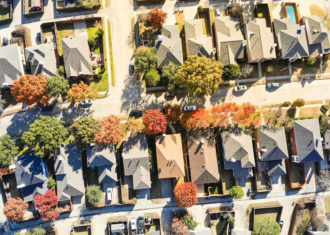Aerial view of median single-family houses in a suburban neighborhood in Dallas, Texas.