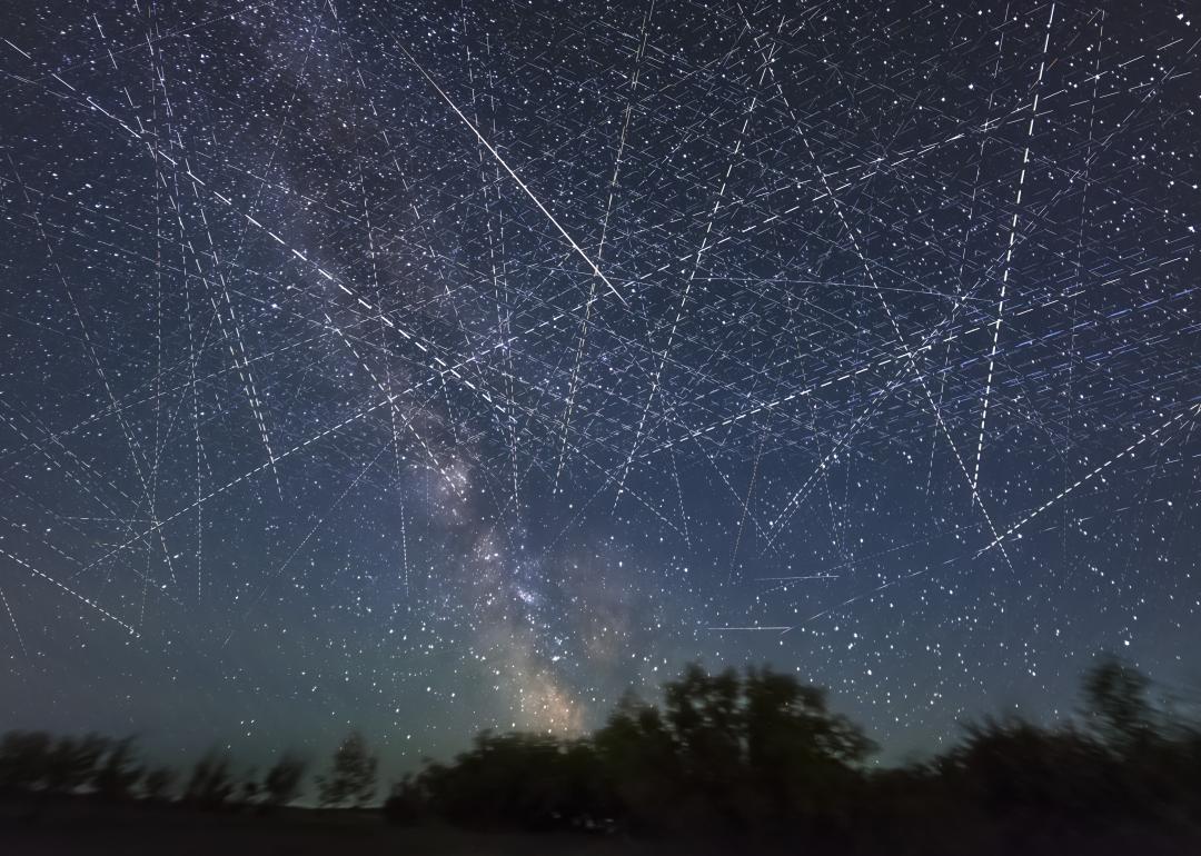 Long-exposure taken over 30 seconds showing many satellites moving across the night sky appearing as dotted lines.