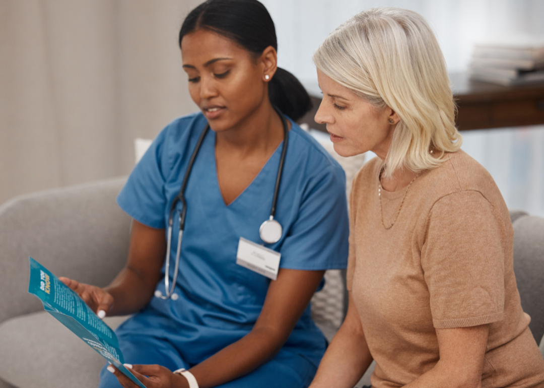 A medical professional reading an informational pamphlet to a patient