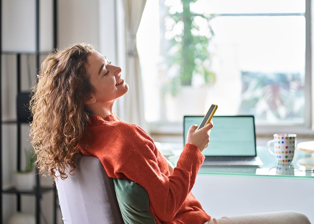 Young woman happily relaxing during a break at work showing a positive work-life balance.
