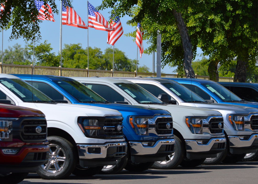 A row of Ford F-150 trucks for sale at a car dealership