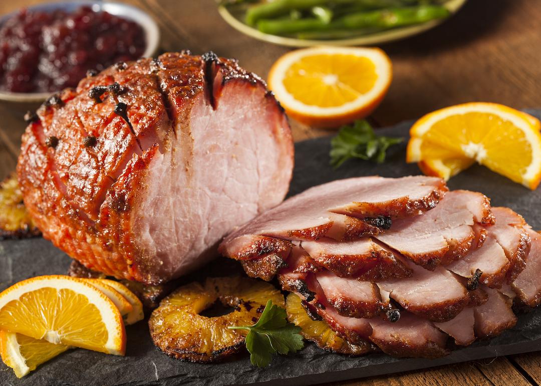Sliced honey-glazed ham with pineapple.