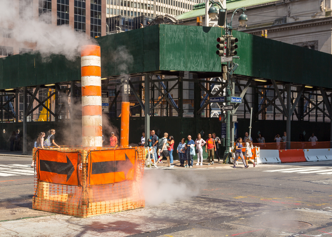 A steam pipe vent and scaffolding on the streets of New York City