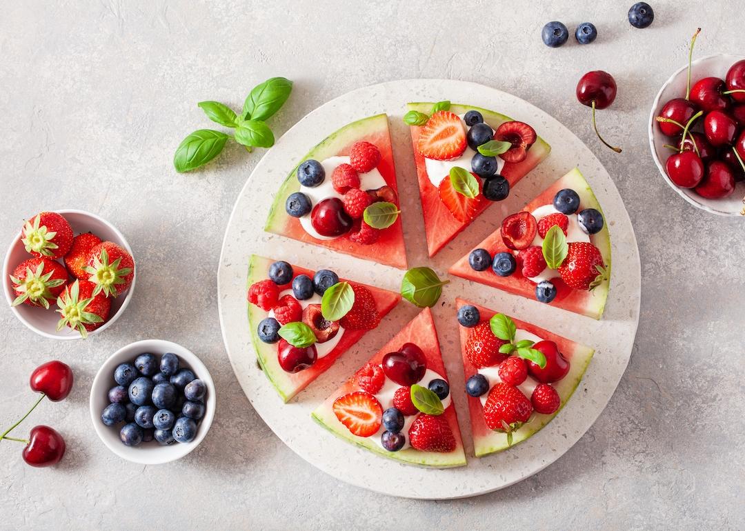 Watermelon pizza slices with yogurt and berries.