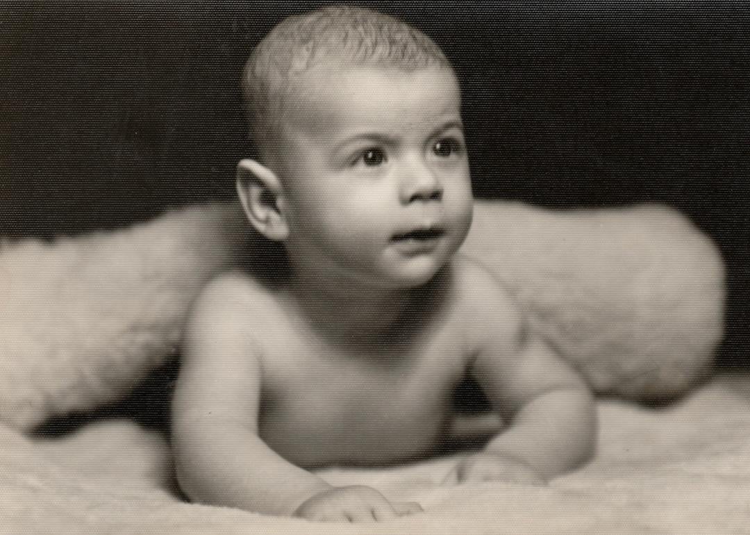 Small baby lying prone position, circa 1950s.
