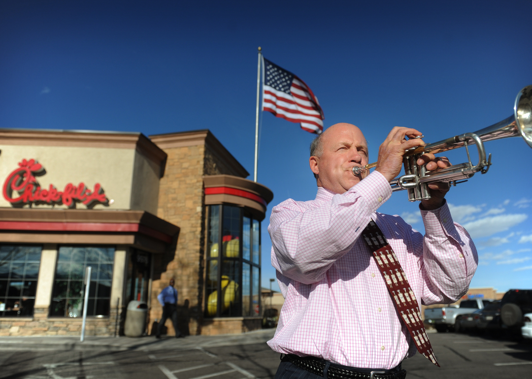 Chick-fil-A Inc. chairman Dan Cathy, son of the chain's founder Truett Cathy, sounds the trumpet while visiting one of his franchises