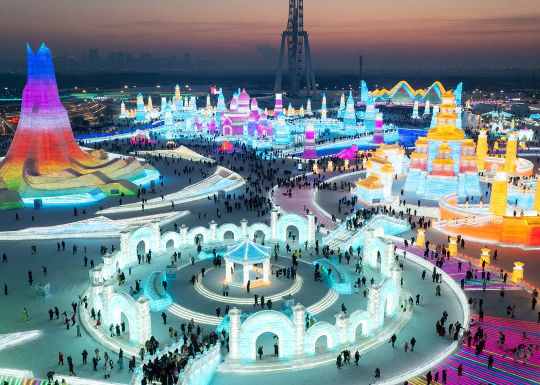 Tourists visit the 25th Harbin Ice and Snow World, one of the world's leading theme parks featuring large-scale ice and snow sculptures, on December 22, 2023 in Harbin, Heilongjiang Province of China.