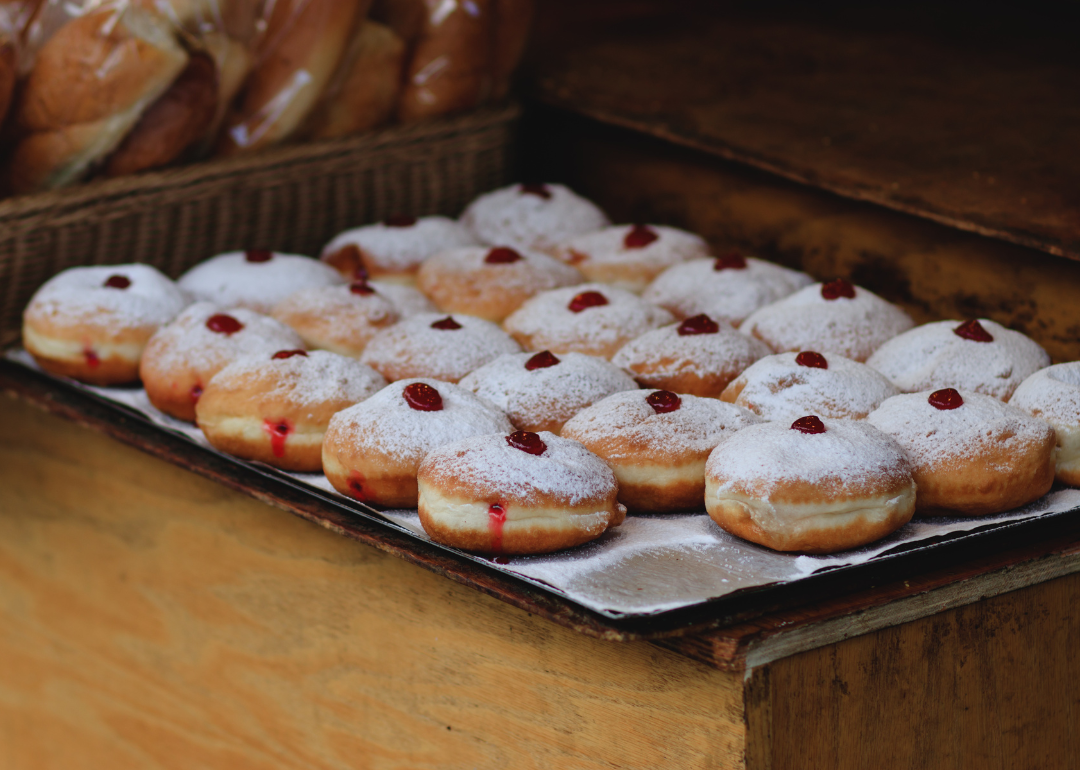 A baking tray full of freshly made sufganiyot