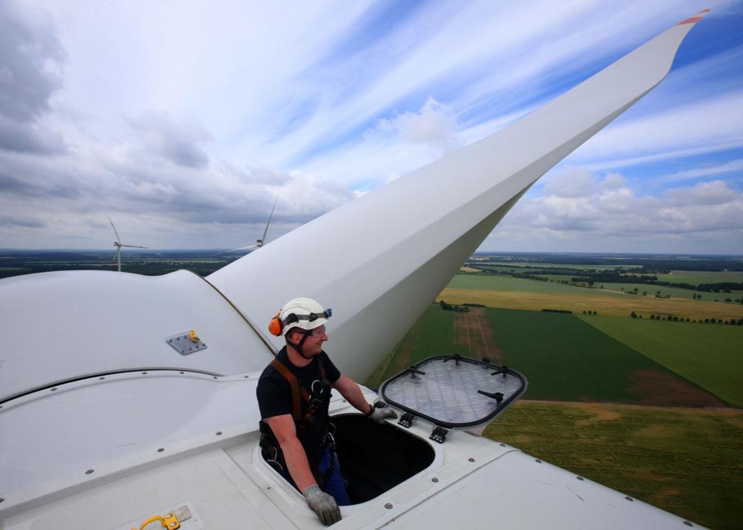 Service technician Andre Sebesta sits on the new Vestas V112 wind turbine at the wind farm in Barkhagen, Germany